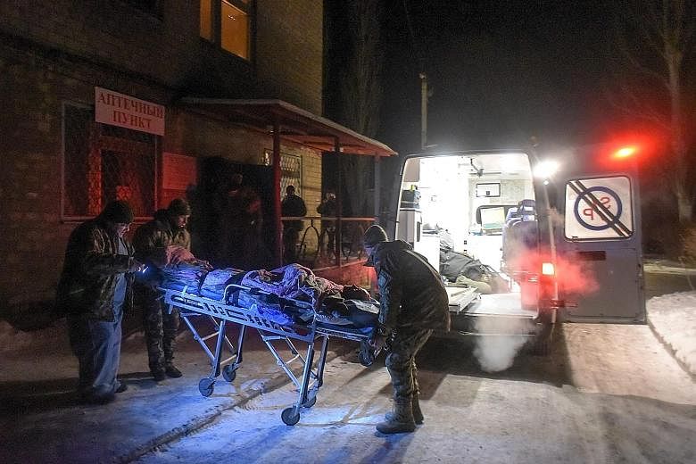 Members of a Ukrainian military medical unit carrying an injured soldier from a hospital to an ambulance as they prepare for evacuation from the eastern city of Avdiivka. Heavy shelling has reportedly been going on in the town since Sunday, and it ha