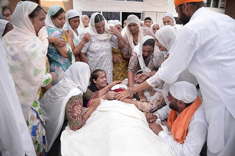 Relatives mourning at the funeral of Mr Jasvir Singh, who was believed to be a drug addict, in the village of Kabir Pur in Punjab's Kapurthala District. Drug abuse has emerged as a major issue in run-up to the elections for the Punjab state assembly.