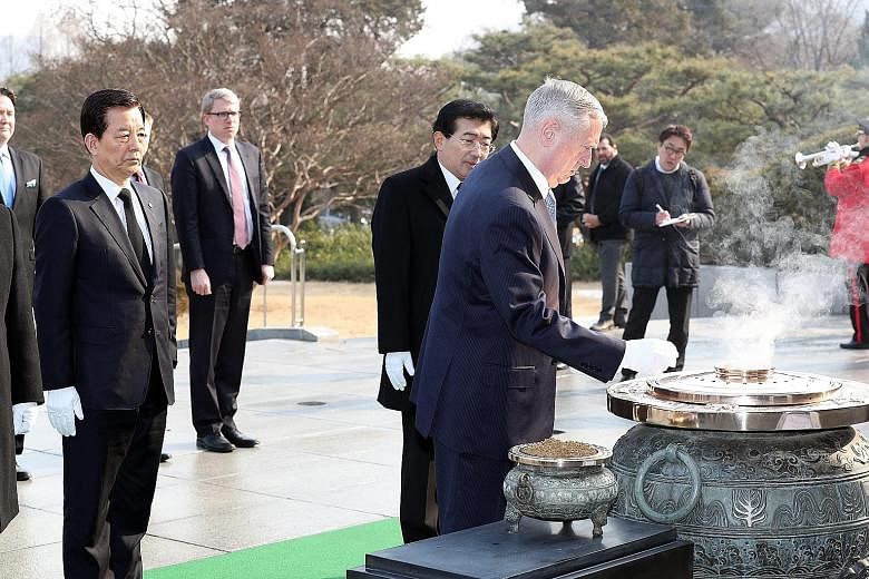 Mr Mattis at the National Cemetery in Seoul yesterday, before he headed to Japan. His visit follows Mr Trump's campaign remarks that the US could rethink its role in North-east Asia.