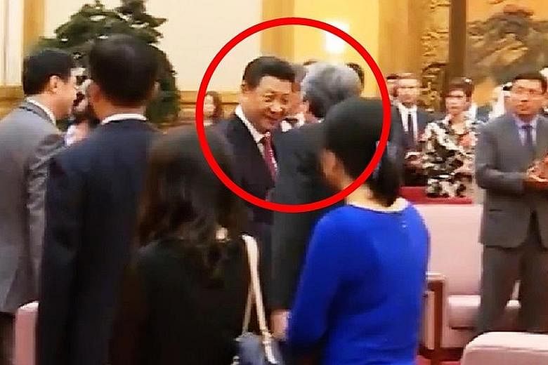 Television news footage showing Mr Xi approaching Mr Tsang (back to camera) to shake his hand at the start of a meeting in June 2015.