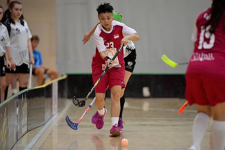 Singapore's player of the match Karen Loo with the ball against New Zealand at the ASB Sports Centre in Wellington yesterday. The Republic beat the hosts 7-1 to seal their spot at the World Championships in Slovakia.