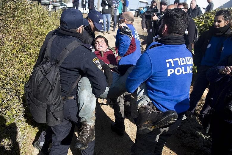 Israeli security forces arresting a settler during the evacuation of a synagogue at the illegal Jewish settlement of Amona, in the West Bank, on Thursday.