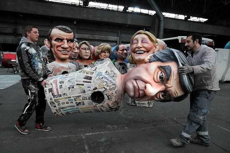 Workers preparing a figure of Mr Fillon for a carnival parade in Nice on Thursday. The former prime minister has denied wrongdoing since graft claims were first reported last week.
