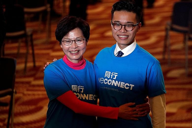 Mrs Lam with her son Jeremy at a Hong Kong election campaign event yesterday. She is widely seen as Beijing's preferred candidate and faces competition from former financial secretary John Tsang, among others.