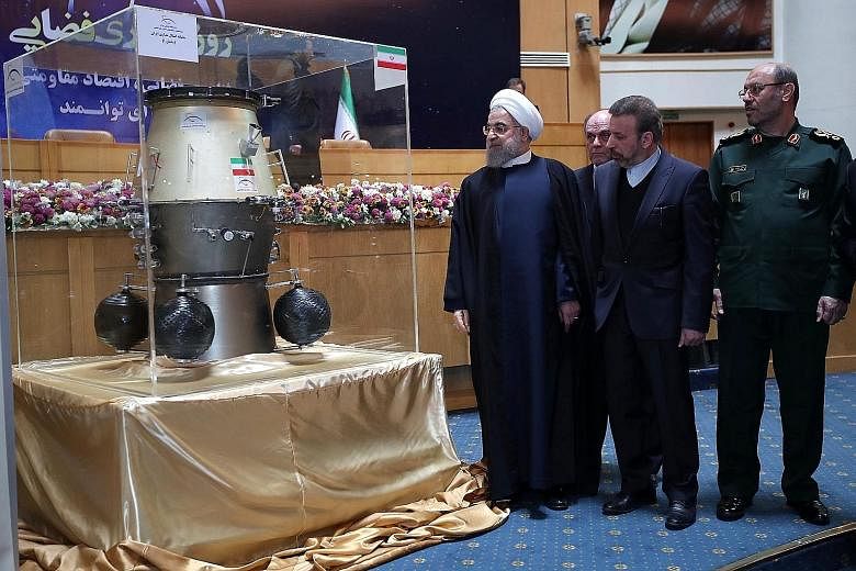 Iranian President Hassan Rouhani at an exhibition showcasing his country's space achievements on Wednesday, the same day that Iran confirmed its first ballistic missile test since Mr Trump took office.