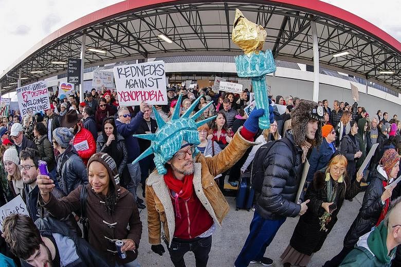 People protesting against the travel ban outside an airport in Atlanta, Georgia, last Sunday. The Trump administration could again block travellers if it wins an emergency stay. Judge Robart was appointed to the federal Bench by then President George