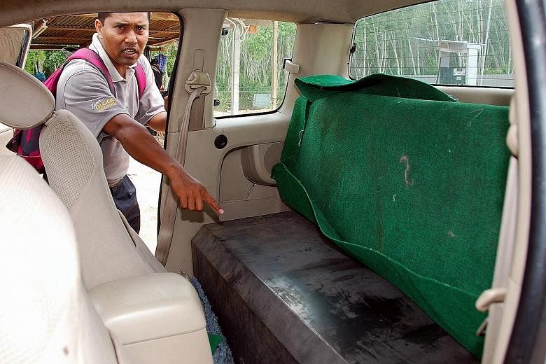 A pick-up (left) with its back seats holding a fuel tank used to smuggle petrol or diesel from Malaysia into Thailand. Malaysian border patrol (right) inspecting a van that had a tank filled with 2,000 litres of fuel to be smuggled into Thailand at B