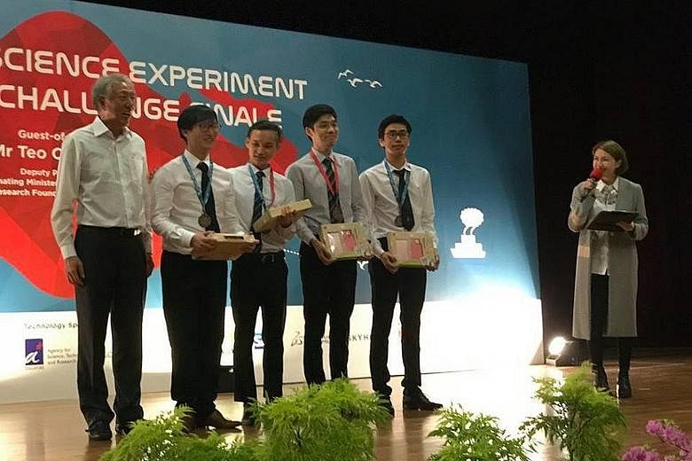 DPM Teo Chee Hean with (from left) students Ngo Wei An, Andre Ang, Noel Sung and Tan Zhen Wen, who were third in their category in the National Science Experiment Big Data Challenge.