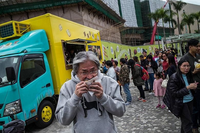 Is HK$20 (S$3.60) for one pineapple bun (bo lo bao) overpriced? Hong Kong chief executive contender John Tsang (left) thinks so. Accompanied by his wife Lynn, the former financial secretary visited a newly opened food truck in Tsim Sha Tsui on Saturd