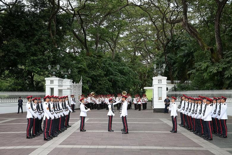 The Singapore Armed Forces (SAF) Military Police Command holding the Changing of Istana Guards Ceremony at the Istana main gate yesterday at 6pm. 	The occasion saw the new batch of guards marching along Orchard Road to take over from the old batch of
