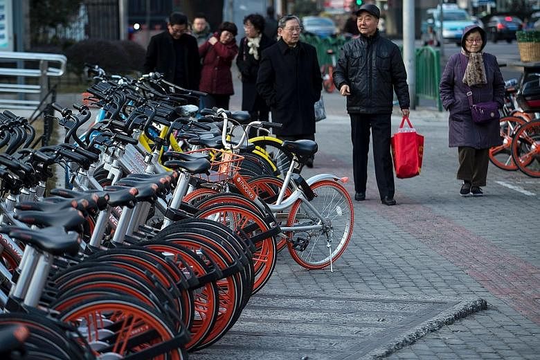 The convenience of being able to drop off a bike anywhere means a new generation of riders is now ubiquitous in cities such as Shanghai (above) and Beijing.