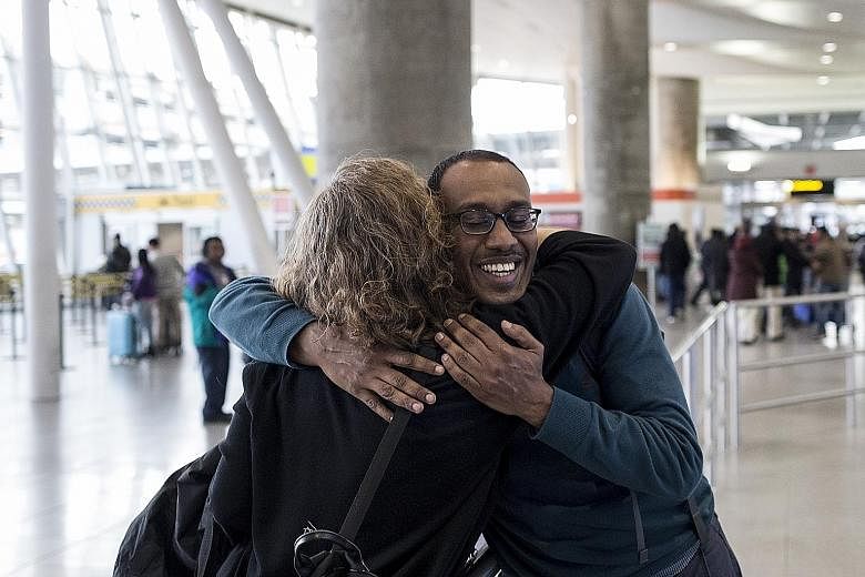 Dr Kamal Fadlalla, who was stranded for a week in his native country Sudan, embracing attorney Anita Eliot upon arrival in John F. Kennedy Airport in New York on Sunday.