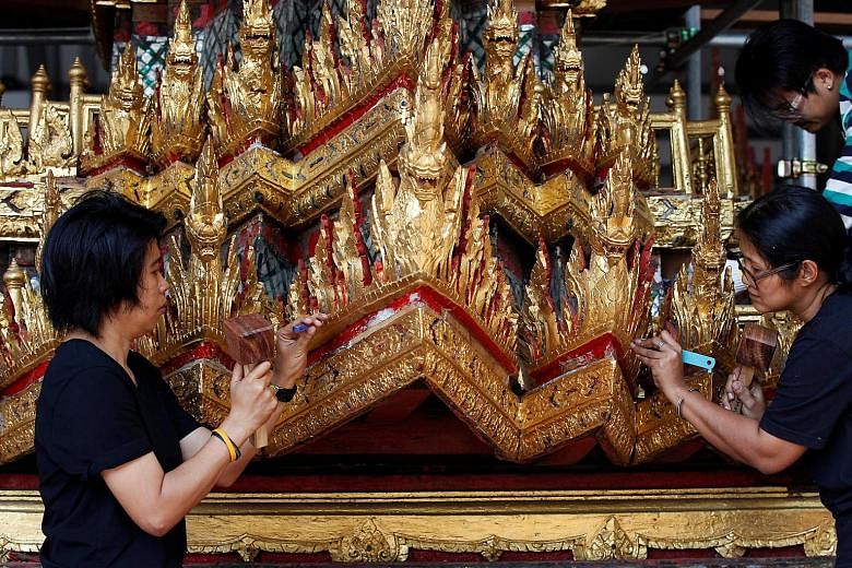 Inch by gilded inch, the chariot to take Thailand's late king on his last journey is being restored by workers in Bangkok in a labour that will last months. Built of wood and decorated with gold and mirrors, the 13.7 tonne chariot is 18m long, 11.2m 