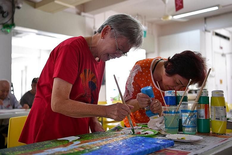 Madam Chaw (left) said she has become more cheerful and patient after taking up painting and dancing as part of the Fine Arts Programme at the Care Corner Senior Activity Centre in Toa Payoh. Mr Lim Suey Teng (centre), 67, practises his dance moves w