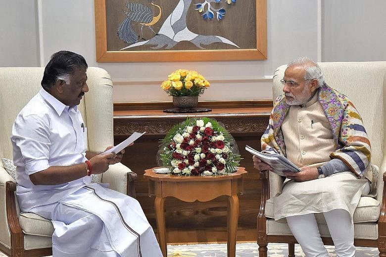 Left: Mr Panneerselvam (far left), seen here in a meeting with Prime Minister Narendra Modi in New Delhi, served as interim chief minister and has said he is ready to continue as state chief, but was sacked as party treasurer and faces expulsion from