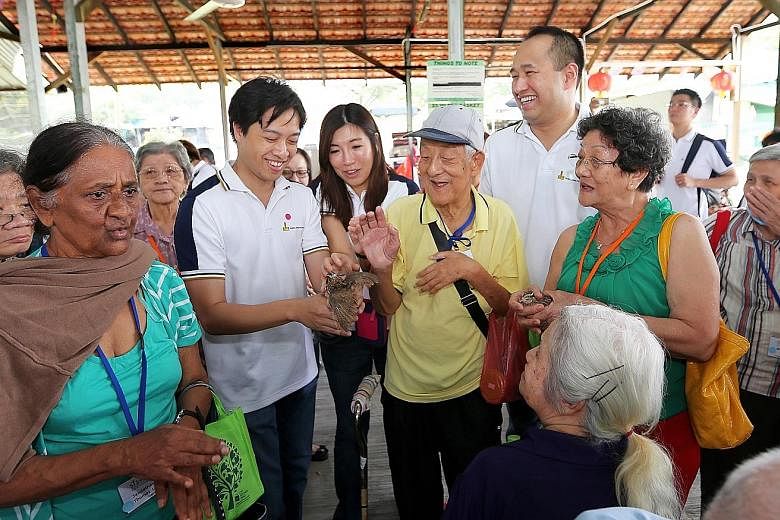 Hong Leong Foundation governor Kwek Eik Sheng showing a quail to seniors from the Henderson Senior Citizens' Home and St John's Home for Elderly Persons at the Farmart Centre in Sungei Tengah Road. Sixty elderly beneficiaries from the two facilities 