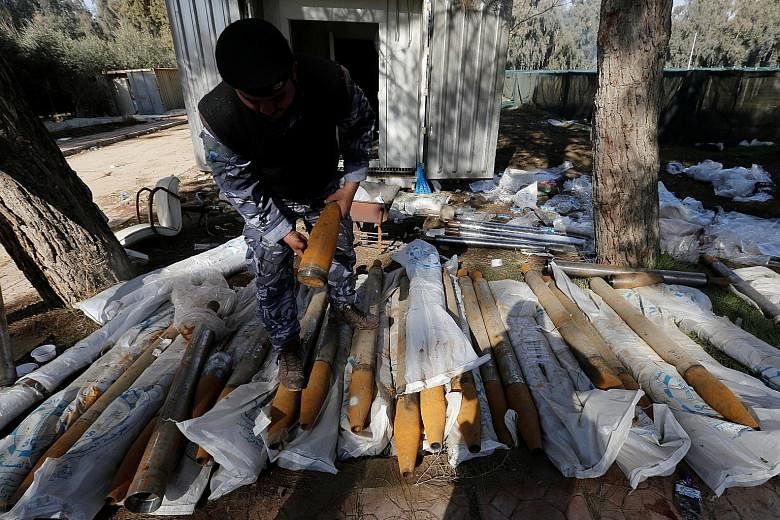 An Iraqi federal police officer inspecting weapons used by ISIS militants in Mosul.
