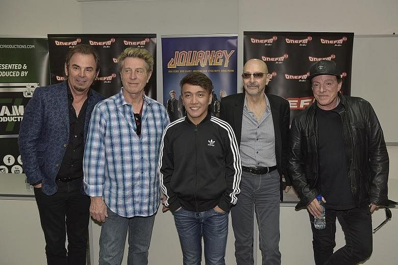 Journey, which comprise (above, from left) Jonathan Cain, Ross Valory, Arnel Pineda, Steve Smith and Neal Schon, at a press conference held at SPH News Centre yesterday.