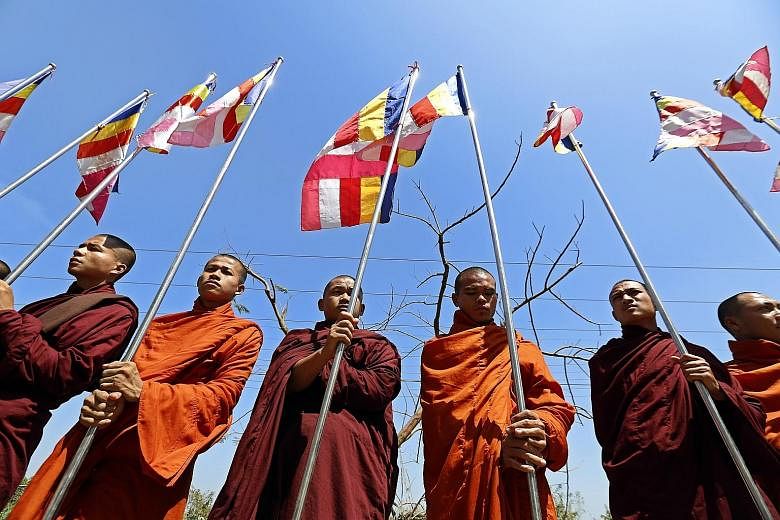 Buddhist monks at Thilawa port in Yangon yesterday, to await the arrival of a ship carrying aid for the Rohingya. The monks want to send the message that there is "no Rohingya" in the country.