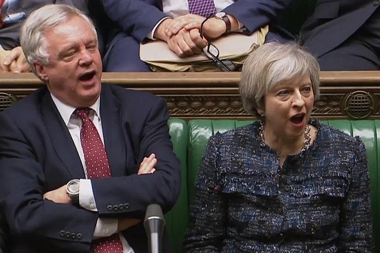 Mrs May and Brexit Minister David Davis shouting "aye" during voting on Wednesday for a third reading of a Bill empowering the British Prime Minister to start Brexit negotiations. The Bill was approved in the House of Commons with a majority of 494 a