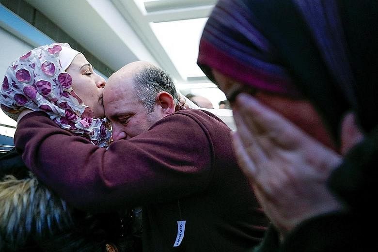 A Syrian refugee hugging her father after arriving at O'Hare International Airport in Chicago on Tuesday, as her mother sheds tears of joy. The number of Christian refugees entering the United States was almost at the same level as Muslims in 2016.