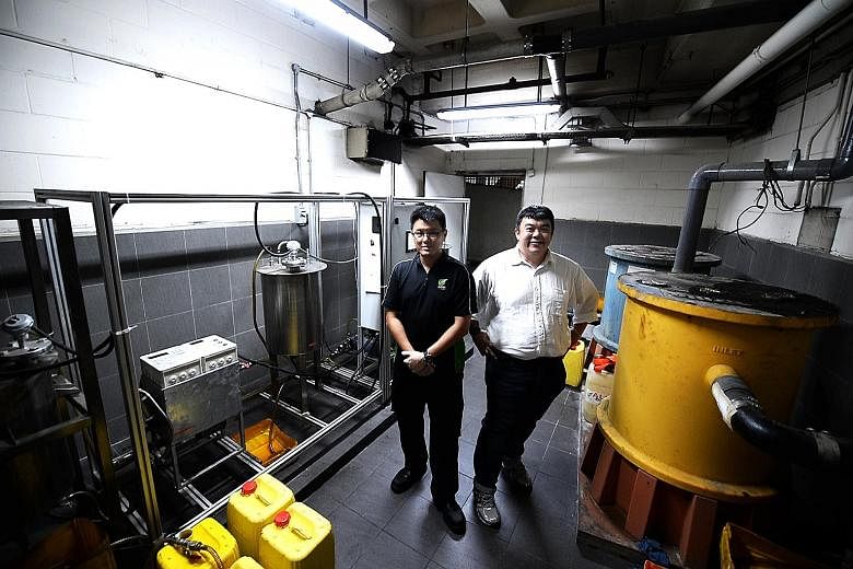 Mr Lim (right) with Alpha Biofuels' chief operations officer Jack Ling. The firm's recycling facility at Raffles City Shopping Centre converts used cooking oil into biofuel to power vehicles, generators and forklifts.