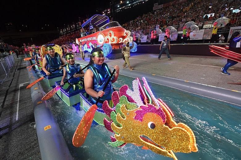 Performers simulating a dragon boat race in one of the segments in the show, which also featured iconic performances from the 1970s. Left: Water from a mock moat splashed onto the audience last night as dancers frolicked in it. Above: Traditional Chi