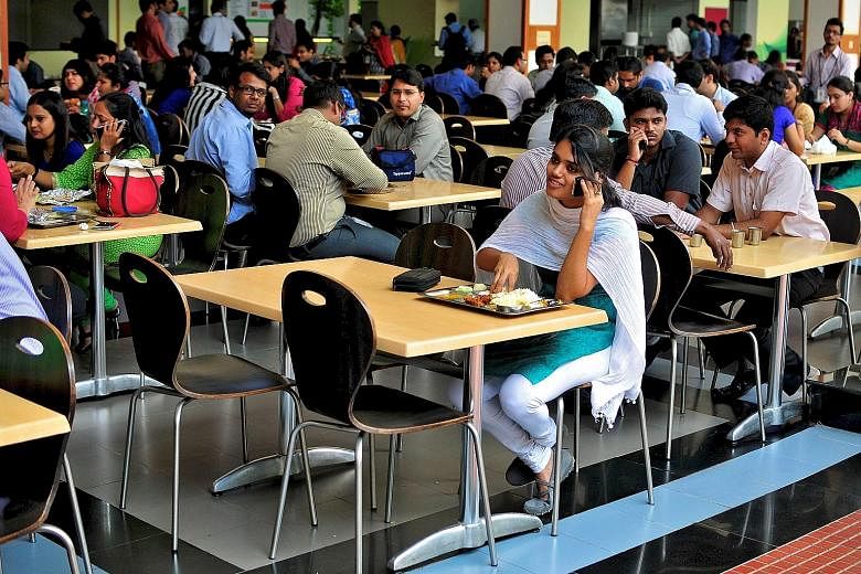 Workers in the cafeteria of Infosys' headquarters in Bangalore. Firms such as Infosys send their engineers to the US for projects under the work visa.