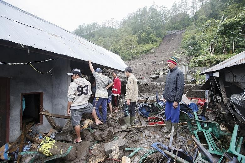 Residents of a village destroyed by the landslides search for their belongings. Several houses were also buried in the incident. Local disaster agency officials said villagers have been evacuated from the affected areas, which are far from the popula