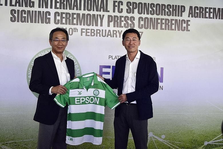 In a gesture to reaffirm their partnership, S-League football club Geylang International's chairman Ben Teng (right) presented an Eagles jersey to Toshimitsu Tanaka, Epson Singapore's managing director (South-east Asia) yesterday at a signing ceremon