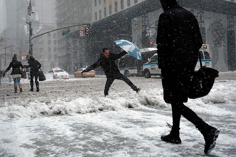 Roads and pavements in New York were left dangerously slick on Thursday as the north-eastern US was pummelled by the fiercest snowstorm of the winter. At least two deaths were blamed on the storm, which led to thousands of flights being cancelled and