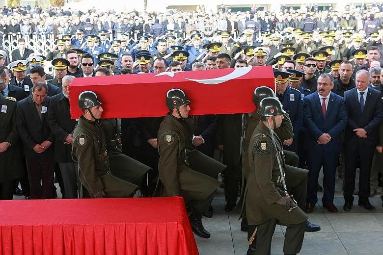 Military honour guards bearing the coffin of a Turkish soldier killed on Tuesday in an ISIS attack around Al-Bab in Syria. The funeral ceremony took place in Ankara in Turkey on Thursday, the same day that a Russian air strike in northern Syria inadv