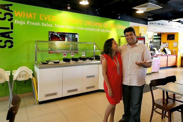 Mr Anant Hada and his wife, Jaya, at their Mexican restaurant Baja Fresh in Rendezvous Hotel last Sunday. Mr Hada was one of only a handful of SMU graduates who managed to secure an investment banking job at the age of 21. But after more than five ye