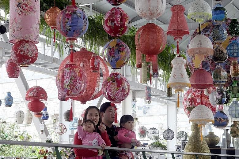 Above: Eco-friendly lanterns made by artist Lin Chow-chin go on display in Yilan, eastern Taiwan, for the annual lantern festival. Left: Mr Lin showing how his lanterns can be recycled as a vase, by replacing the bulb with a water bottle.