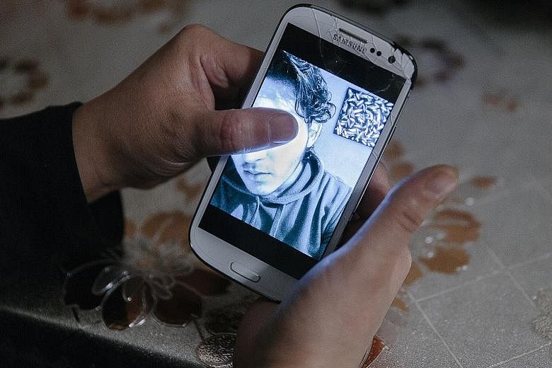 A boy charged over a bomb attack at a Sikh temple in Essen, in a photo displayed on his mother's phone.
