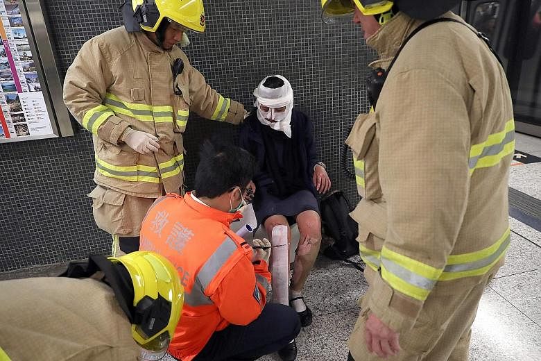 A passenger receiving medical assistance from Hong Kong rescue personnel. Reports said a man hurled a lit Molotov cocktail on board the packed train. The damaged train as it was about to pull up at the platform of Tsim Sha Tsui station. Safety fears 