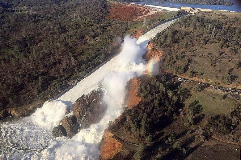 The damaged spillway with eroded hillside in the Oroville Dam area in California. Crews using helicopters prepared to drop rocks to seal the spillway, and the authorities were releasing water to lower the lake's level after weeks of heavy rain in the