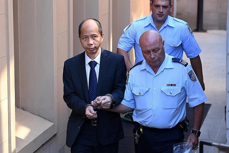 Xie being led away yesterday, after being found guilty of murdering five of his relatives. He plans to appeal. The parents of Mr Norman Lin with portraits of the slain family members outside the New South Wales Supreme Court in Sydney yesterday.