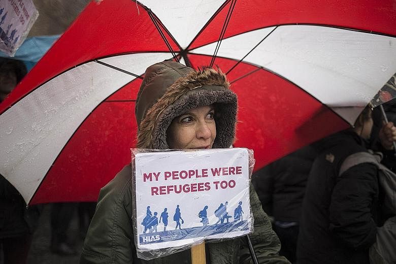 A member of Jewish refugee group Hebrew Immigrant Aid Society rallying against Mr Trump's travel ban in New York City on Sunday.