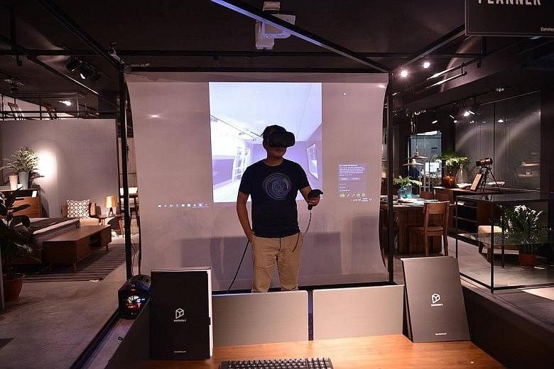 Members of the public can experience the dive for themselves next month, when the prototype of Hiverlab's VR training programme (left) is available at the Infocomm Media Development Authority's Pixel Labs. A customer trying out Commune's VR home-plan