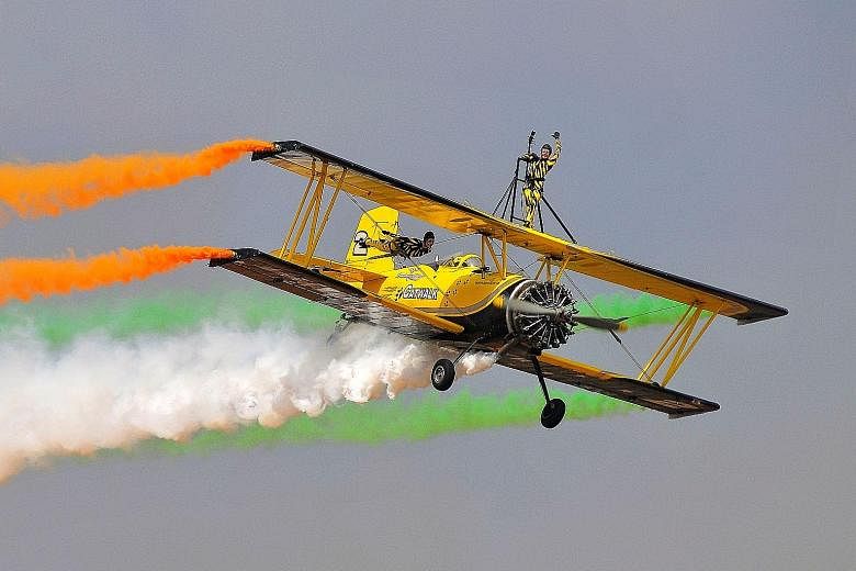 Skycat Wingwalkers from the Scandinavian Airshow team performing at the start of Aero India 2017 in Bengaluru, India, yesterday. Asia's largest air show will draw top military contractors from around the world vying to be part of the government's "Ma