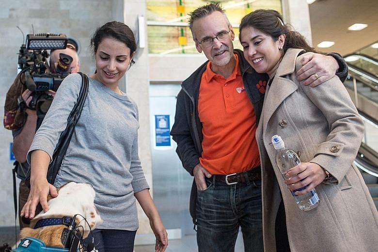 Iranian engineer Nazanin Zinouri (at right) being greeted by her former Clemson University adviser Kevin Taaffe after arriving at an airport in South Carolina earlier this month. While trying to return to South Carolina after visiting her family in I