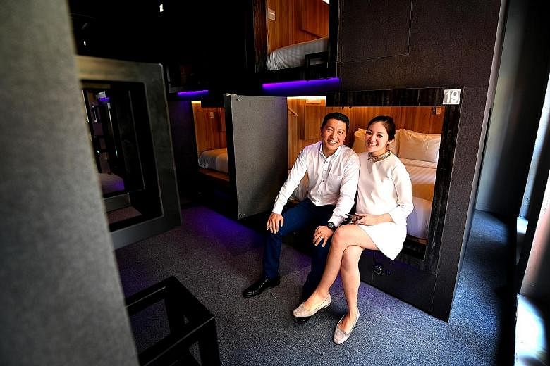 Married couple Benedict Choa and Sonia Anya in one of the rooms at the Cube boutique capsule hotel. Guests get their own private cabin fitted with a reading lamp, a safe, filtered air ventilators and a foldaway dressing table. The cabins are separate