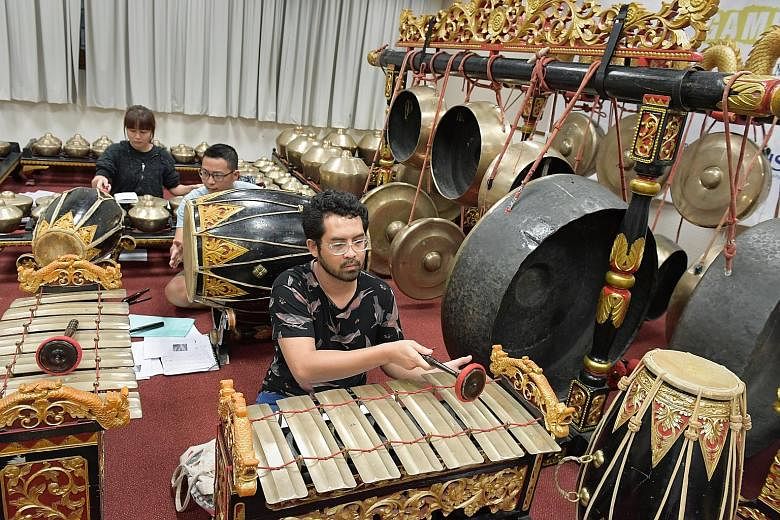 (From far left) Singa Ngalaras Gamelan Ensemble members Lam Guan Yu, Thow Xin Wei and Haider Sahle. About a third of the members of this NUS group are not of Javanese descent.