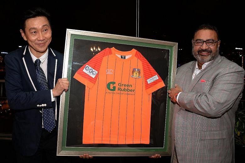 Hougang United chairman Bill Ng and Green Rubber Group chairman and founder Vinod Sekhar displaying the new kit after signing an extension to the sponsorship deal. Among other changes, the club will sell the rights to a new analytics softwa