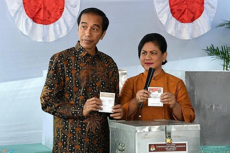 President Joko and First Lady Iriana casting their votes at a polling station in Gambir, near the presidential palace in the capital.