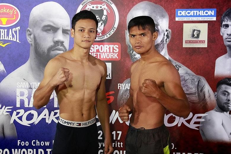 Singaporean professional boxer Muhamad Ridhwan (left) and his opponent Jason Butar of Indonesia posed for the cameras and had the obligatory stare-down at yesterday's weigh-in, ahead of their clash tonight at the inaugural Roar of Singapore boxing ev