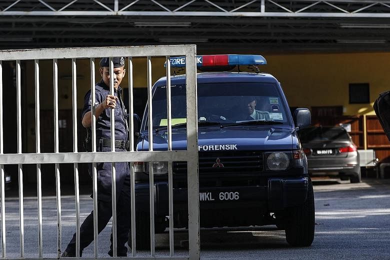 Officials leaving the forensic department of the Kuala Lumpur General Hospital yesterday. A total of three people have been arrested so far in connection with the assassination of Mr Kim Jong Nam.