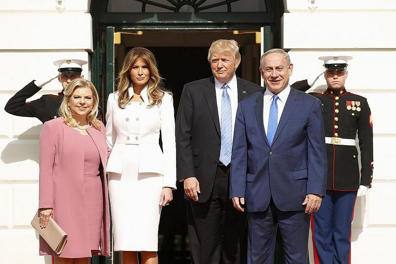 US President Donald Trump and First Lady Melania Trump (centre) with Israeli Prime Minister Benjamin Netanyahu and his wife Sara at the South Portico of the White House in Washington on Wednesday. Mr Trump said he would be happy with either a two-sta