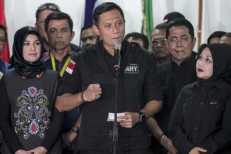 Mr Agus, flanked by his wife Annisa Pohan (left) and running mate Sylviana Murni, conceded defeat in the Jakarta election on Wednesday night. The voters who backed him will now be courted by the campaign teams of the remaining candidates, Basuki and 